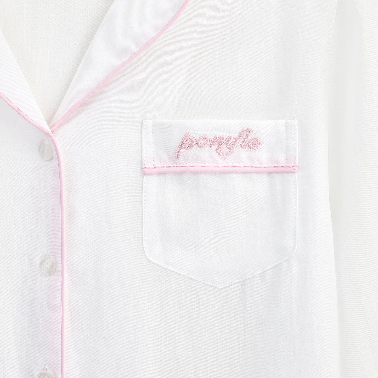 white pyjama shirt pocket detail with pink piping and pomfie embroidery