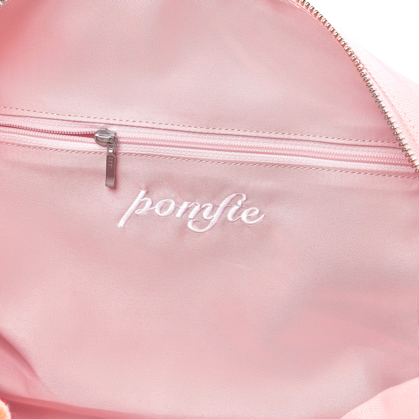 close up inside of twill baby pink cotton bag. ykk silver zip detail inside pocket.