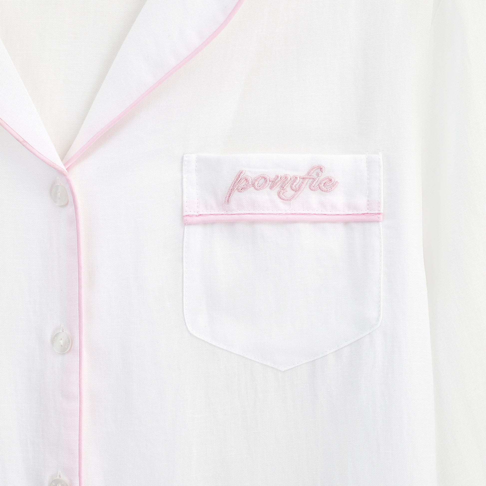 white pyjama shirt pocket detail with pink piping and pomfie embroidery
