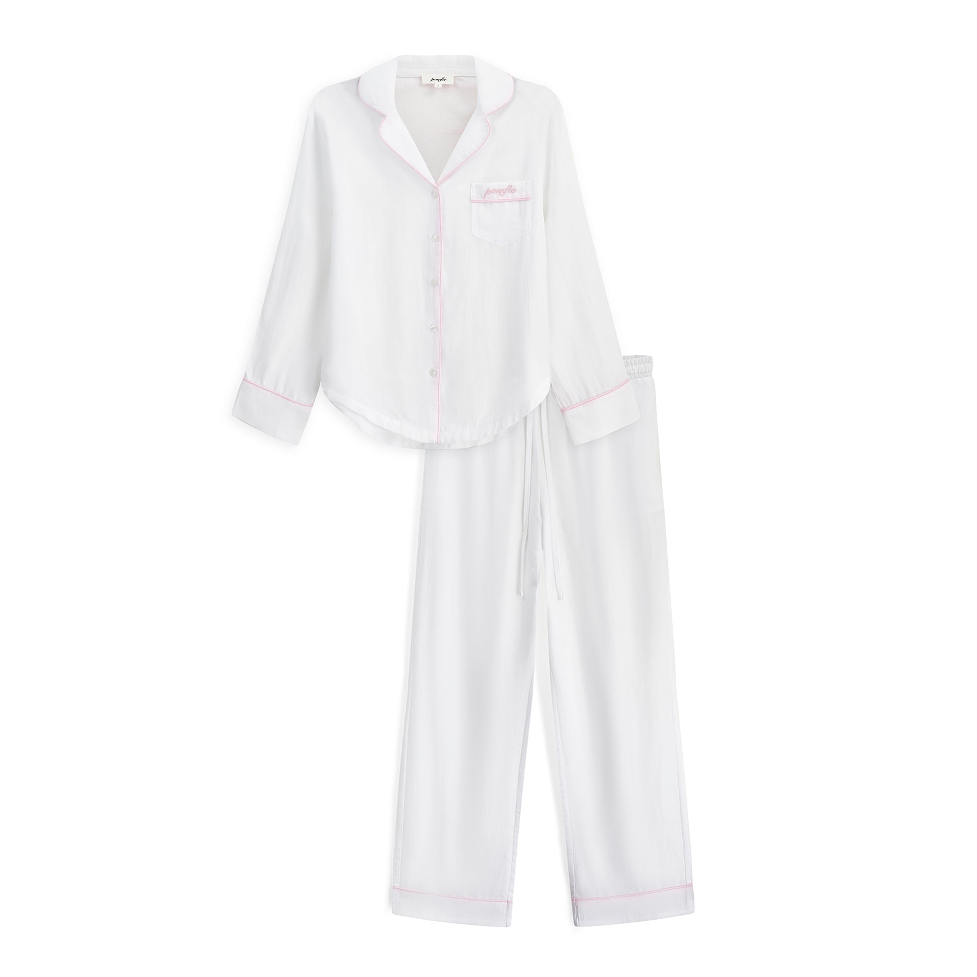 white pyjama set with baby pink piping details and pomfie logo embroidery.